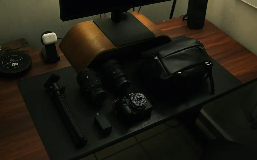 Camera bodies and lenses laid out on a dark desk