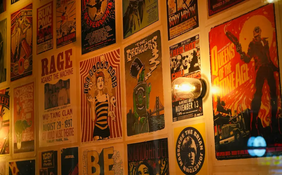 A wall densely covered in printed posters